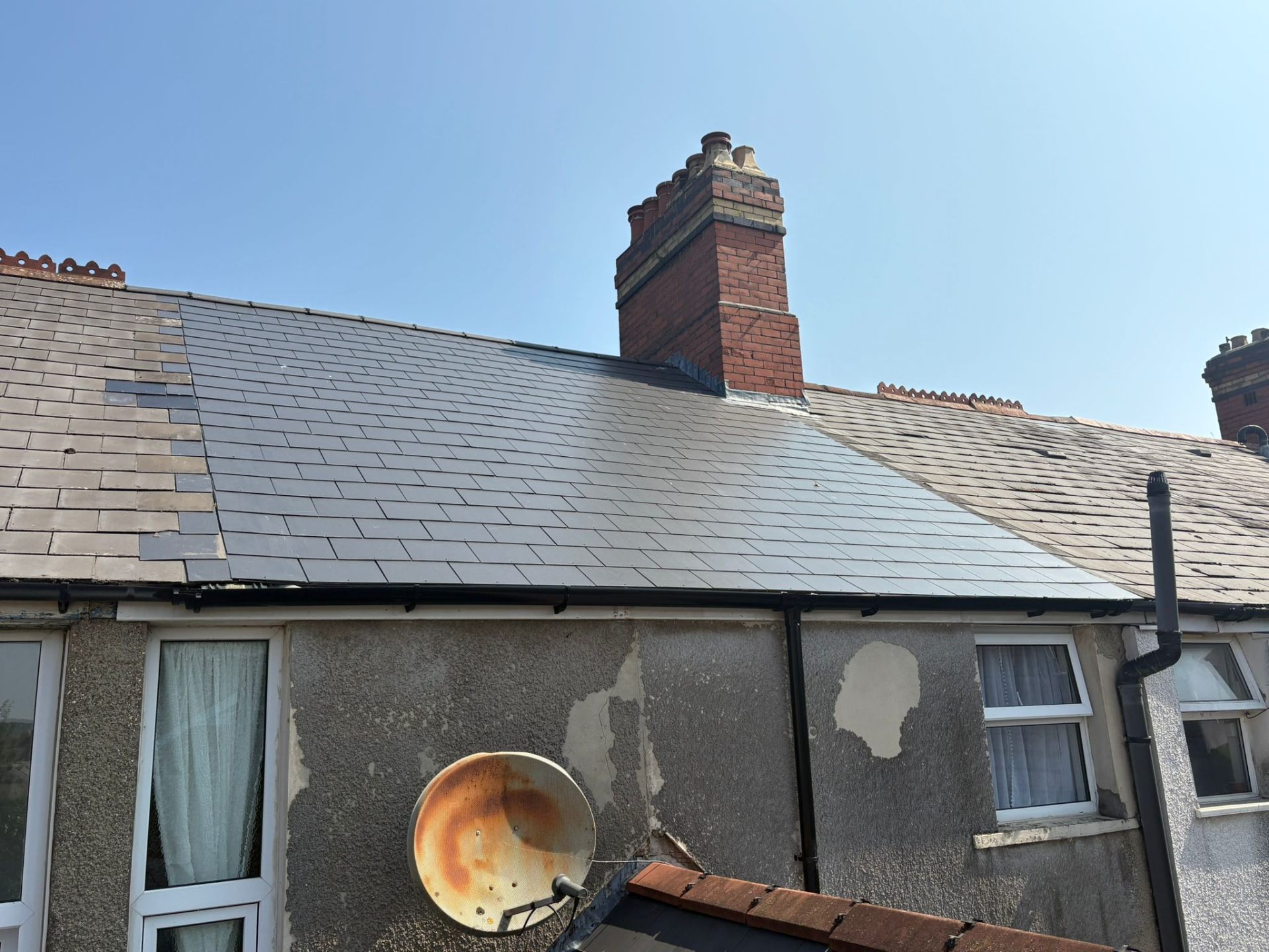 Professional clay tile roof with neat ridgeline on a British residential property