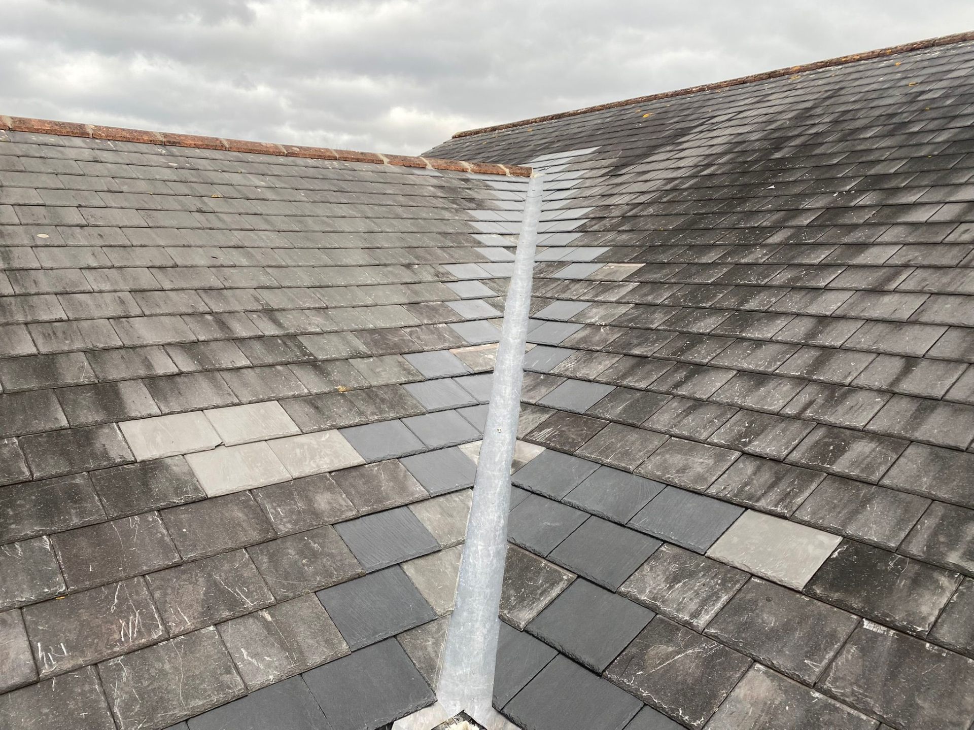 Slate roof valley with new lead flashing repair work completed in Gloucestershire